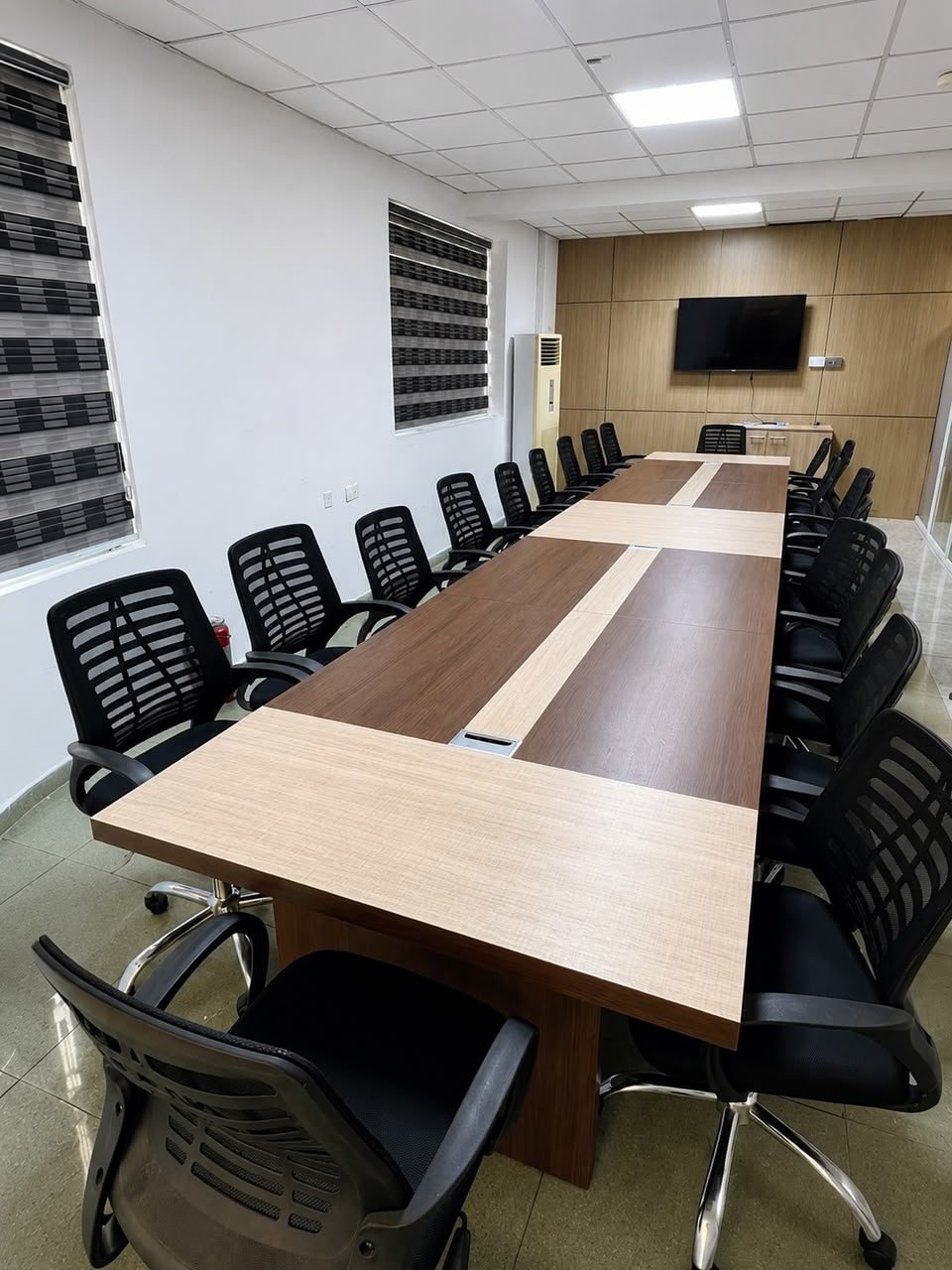 Excel Global conference room with a large boardroom table and chairs